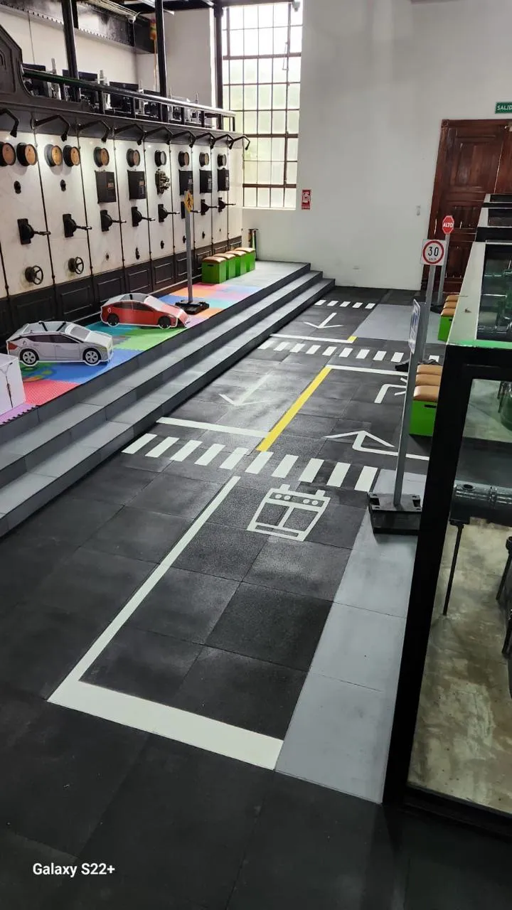 Children's road-safety circuit with signs and markings painted on rubber flooring