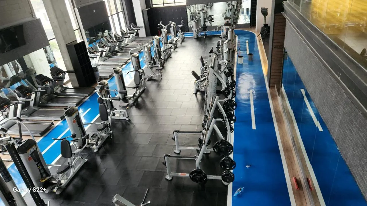 Overhead view of a gym with treadmills and a blue rubber track