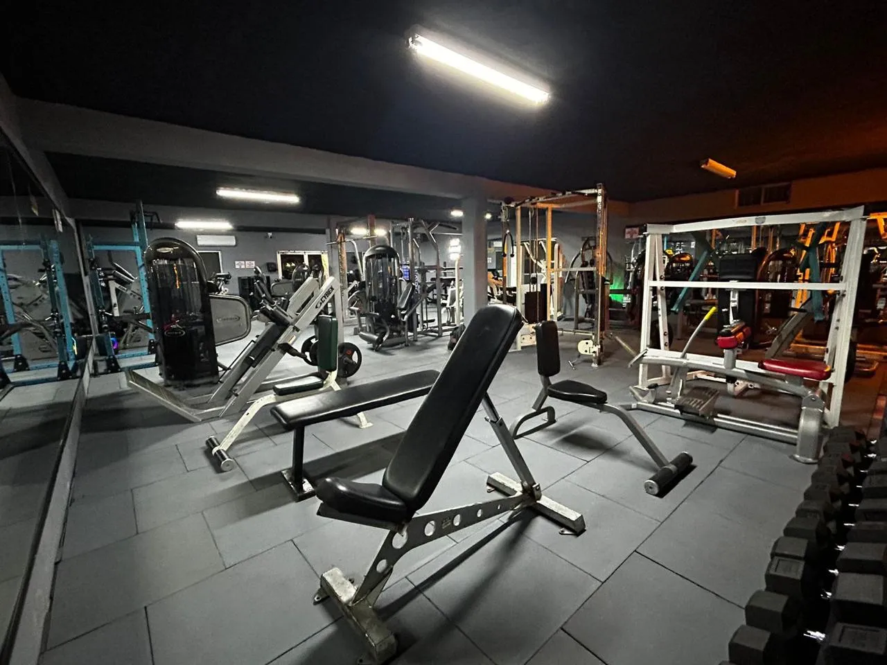 Weight room with equipment on gray rubber tile