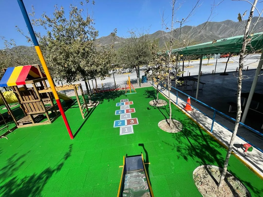 Hopscotch painted on green rubber tile in an outdoor school yard