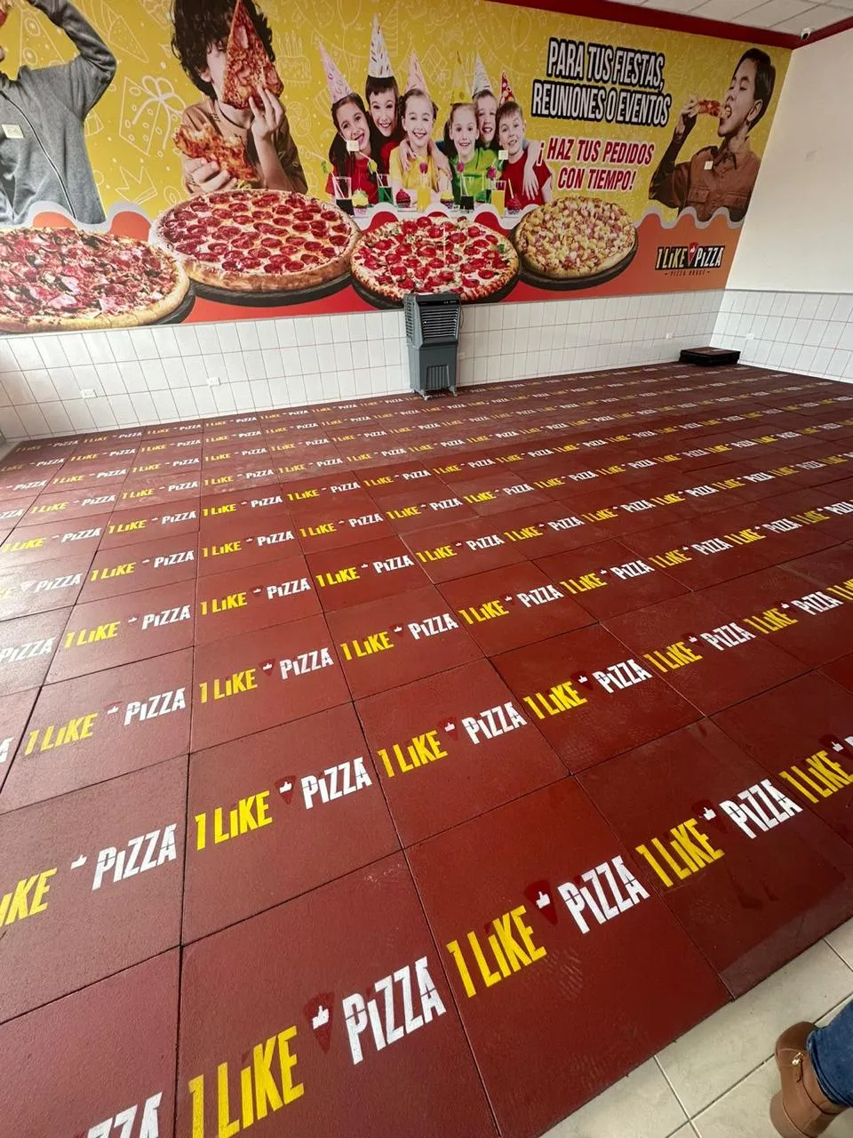 Pizzeria party room with rubber tile printed with the client's own branding