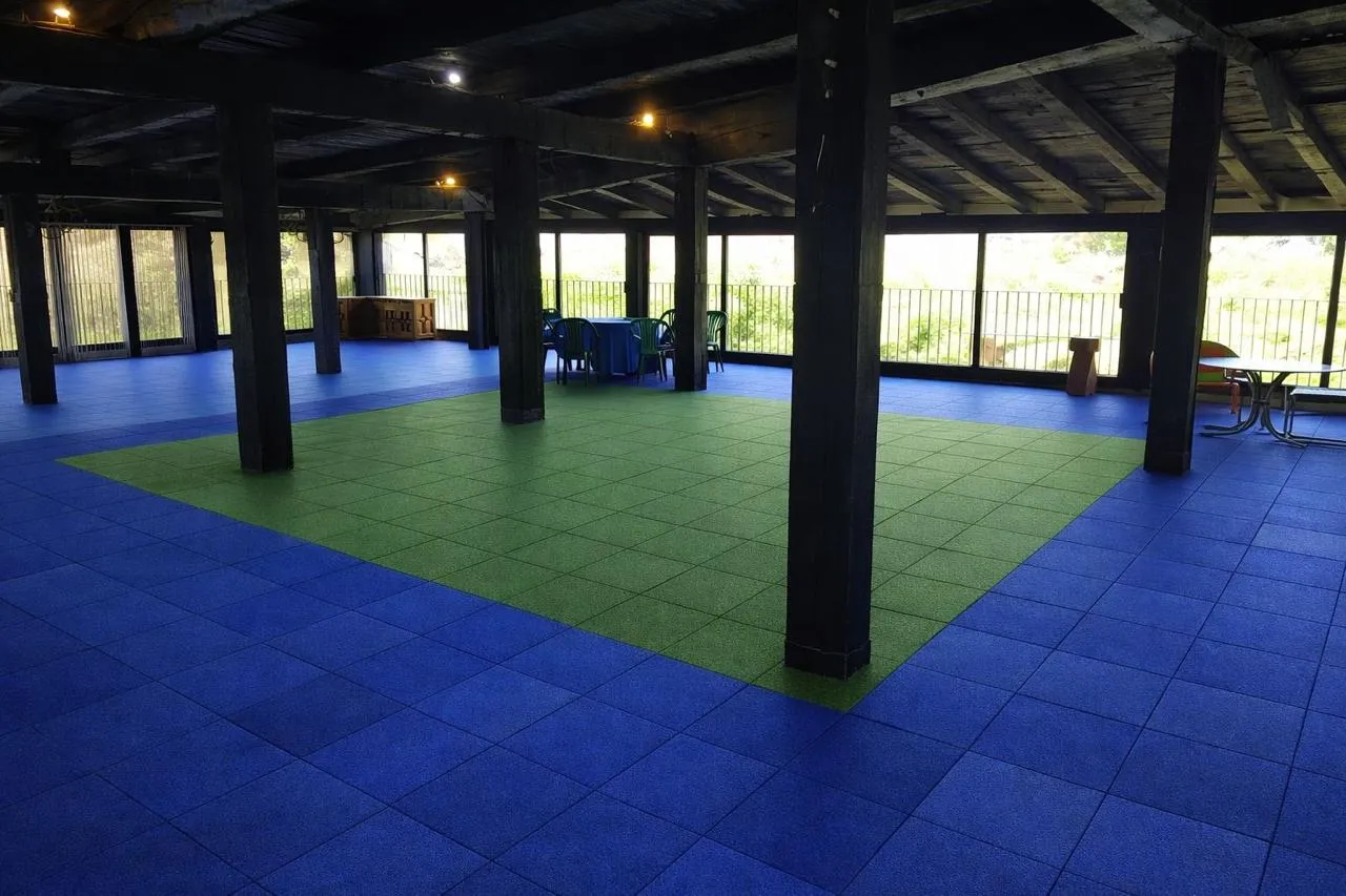 Covered event hall with blue and green rubber tile