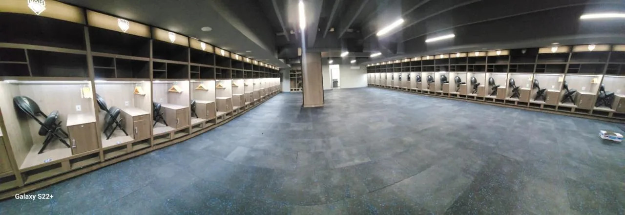 Sports locker room with black rubber flooring flecked in blue